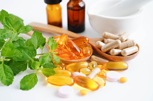 Alternative medicine herbal organic capsule with vitamin E omega 3 fish oil, mineral, drug with herbs leaf natural supplements for healthy good life.